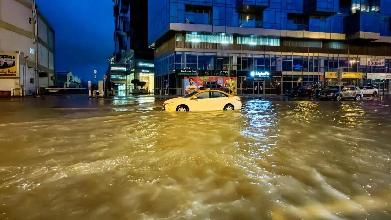 दुबई में भारी बारिश के बाद सड़कों पर भरे पानी में कारें फंसी हुई देखी गईं. तस्वीर/एएफपी